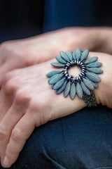 My Spotted Daisy Bracelet worn by a model in oxidised silver with a large bobbled charm flower