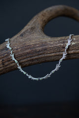 The links are made of small ‘antlers’ finished with my signature dotty texture and adorned with green peridots.
