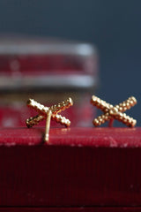 My Tiny Kiss Cross Studs are formed from a tiny cross or kiss.