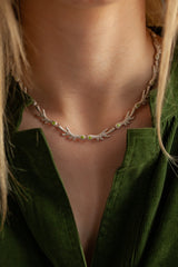 The links are made of small ‘antlers’ finished with my signature dotty texture and adorned with green peridots.