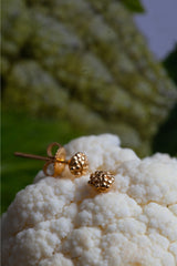 Small stud earrings covered with varying small dots of metal