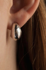 My Silver Cup Earrings worn in silver curve round under the earlobe and hang from a stud