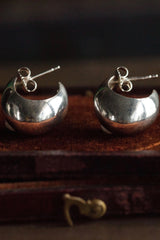 My Silver Cup Earrings in silver curve round under the earlobe and hang from a stud