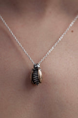 My Tiny Bee necklace worn by a model with gold wings and oxidised silver body