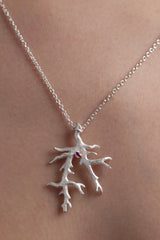 My unusual branch pendant worn by a model, set with an Amethyst, February's birthstone, hangs from a delicate trace chain that can be worn at two lengths