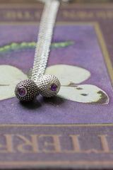 A pair of my special birthstone pendants for February in silver and oxidised silver.  The centrepiece is a tactile textured ball with a glistening Amethyst at the base