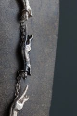 Cloe up of my Weasel Necklace that features 11 miniature weasels chasing each other