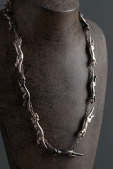 My Weasel Necklace was inspired by a poem and features 11 miniature weasels chasing each other