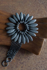 My Spotted Daisy Bracelet features a large bobbled petal charm flower hung between multiple chains