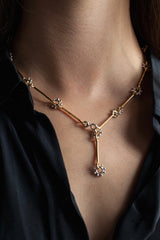 My Daisy Chain Necklace, worn by a model, is formed from strands of silver separated by stylised daisies and can be worn in two ways