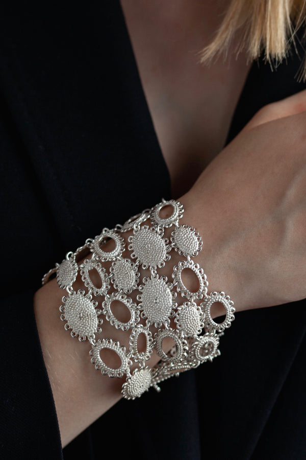 My Baroque Cuff Bracelet in silver worn by a model, inspired by antique lace and ruffs, bring a timeless sense of drama