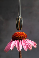 Close up of my Aster Pendant Necklace with a pink flower 