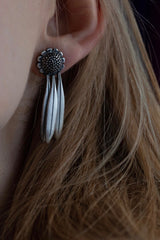 My Aster Daisy Drop Earrings worn by a model has a domed flower head and three petals dropping down