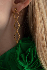 My Kiss Cross Drop Earrings worn in gold plated silver link a row of three crosses or kisses