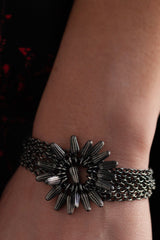 Model wearing my Pod Flower Bracelet with chains holding a flower of little pod shaped charms