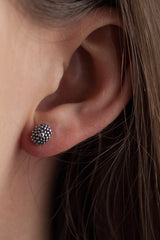 My Snake Eye Stud Earrings worn in oxidised silver feature a bobbled textured oval serpent's eye motif