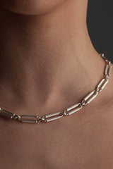 Twenty circular links are re-imagined in this unusual necklace. Striking straight-sided bars with diagonal stripes reminiscent of classical architecture or playful candy canes draw the eye