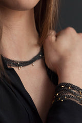 My Five Strand Trace and Pip Necklace worn in contrasting metals, five delicate oxidised silver chains, decorated on the necklace with silver pips and the bracelet with gold plated pips