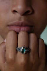 The centrepiece of this ring is an incredible green Cat's Eye Tourmaline, set in 9ct yellow gold and housed in a textured blacked oxidised silver ring.