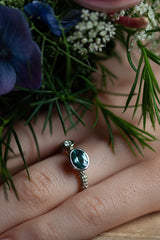 A one off Blue Tourmaline in 9ct white gold cup setting with a white diamond on 9ct white gold band