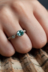 A one off Blue Tourmaline in 9ct white gold cup setting with a white diamond on 9ct white gold band