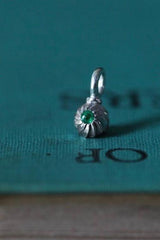 A delicate swirling gemstone charm – choose an Emerald for your May birthday.