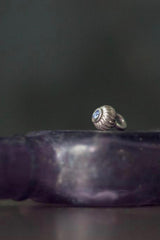 A delicate striped gemstone charm – choose a Tanzanite for your December birthday.