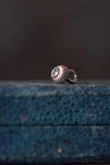 A delicate striped gemstone charm – choose a London Blue Topaz for your November birthday.