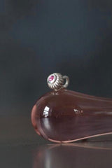 A delicate striped gemstone charm – choose a pink Tourmaline for your October birthday.