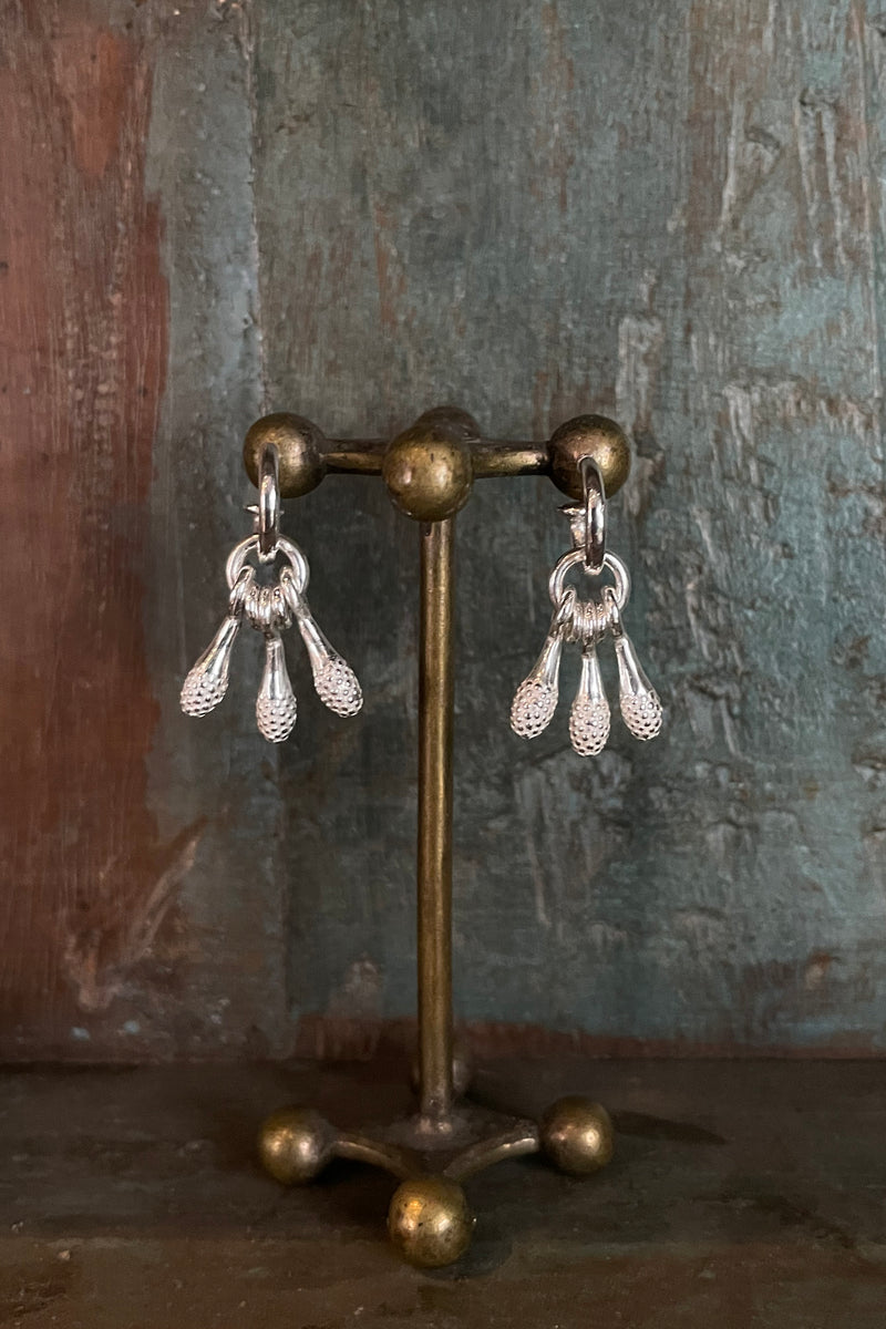 A trio of silver drop charms inspired by matchsticks