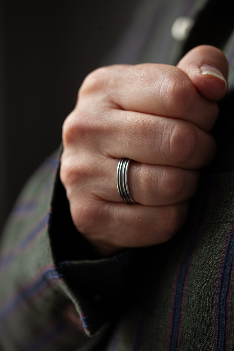 A timeless silver ring with an industrial edge. The lines add depth and interest to this modern ring.