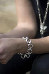 My striking Textured Hoop Bracelet worn in silver features oversized hoops joined by shiny links 