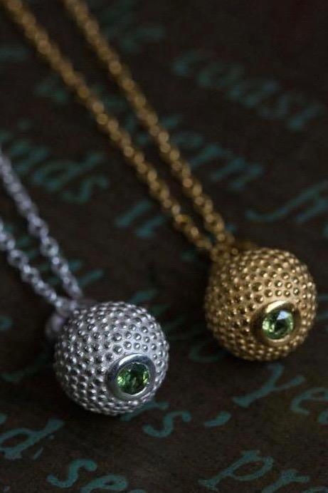 A pair of my special birthstone pendants for August – its centrepiece is a tactile textured ball with a glistening Peridot at the base