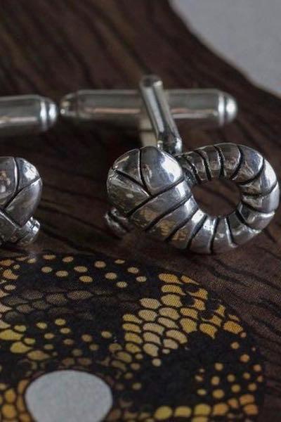 My Snake Cufflinks, inspired by Harry Potter's Slytherin Snake and Flobberworm, feature a neatly crossed curling snake