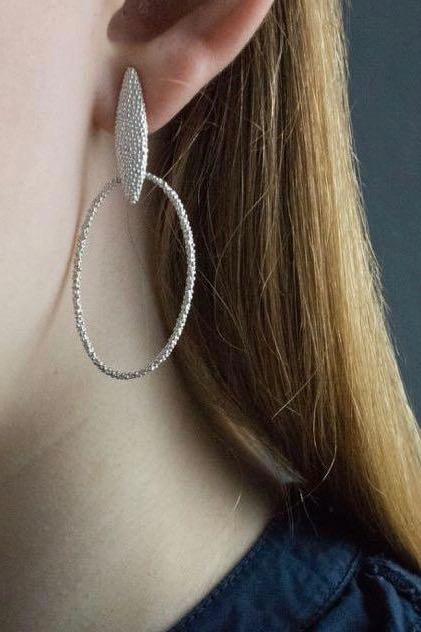 My Petal Oval Hoop Earrings worn by a model in silver