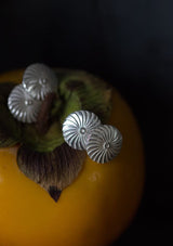 My Catherine Wheel cufflinks feature circular faces with a swirling ridged texture, joined with chain links