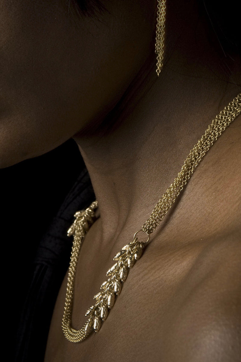 My Rice Pearl Necklace in solid 9ct gold worn by a model features multiple chains decorated with groups of rice pearl beads