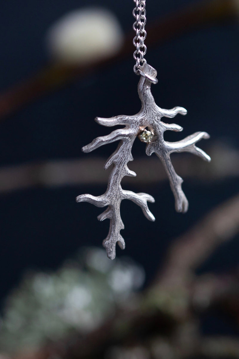 My unusual branch pendant, set with a Cubic Zirconia, April's birthstone, hangs from a delicate trace chain that can be worn at two lengths, is sure to appeal to nature lovers.