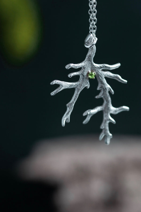 My unusual branch pendant, set with a Peridot, August's birthstone, hangs from a delicate trace chain that can be worn at two lengths, is sure to appeal to nature lovers.