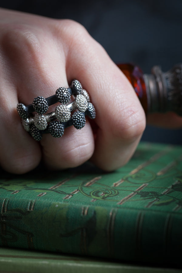 My Snake Eye Trio Ring worn in oxidised silver and silver features 3 ring bands with oval adornments