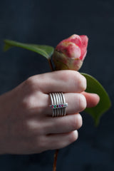 My Six Band Regard Ring worn by a model features 6 gemstones to spell REGARD