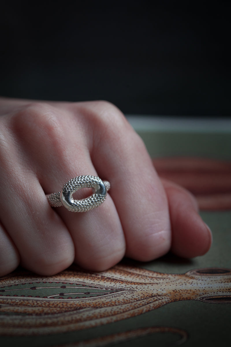 My Squid Ring worn in silver inspired by sea creatures contrasts smooth and spotted textures