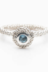 My March Aquamarine Bobbled Pollen Stacking Ring has a bobble textured disc set with an aquamarine gemstone