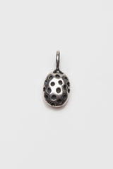 My ladybird charm is a small polished silver oval with different sized spots hanging from small silver ring