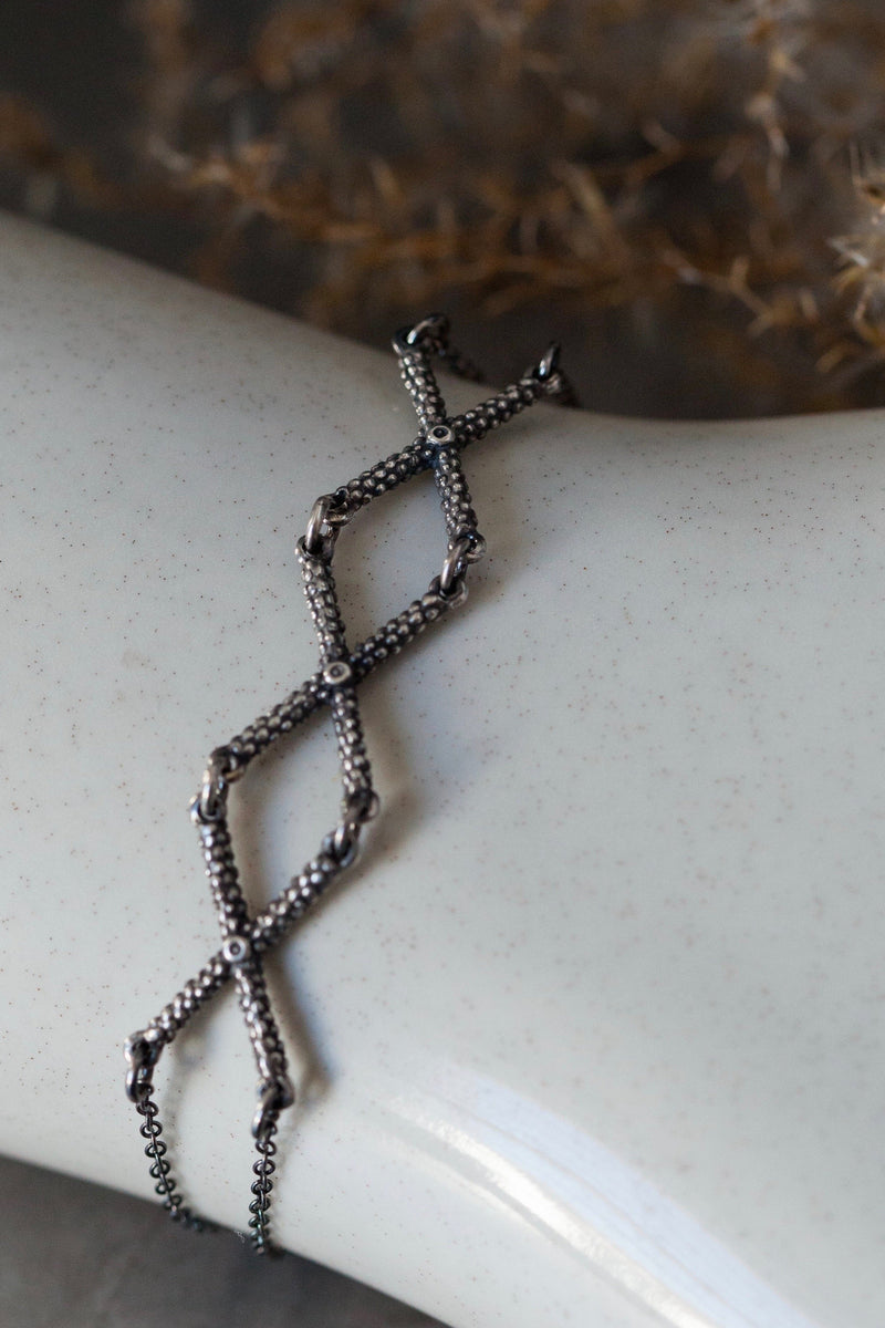 My Triple Kiss Cross Bracelet in oxidised silver features 3 crosses or kisses linked on a simple chain
