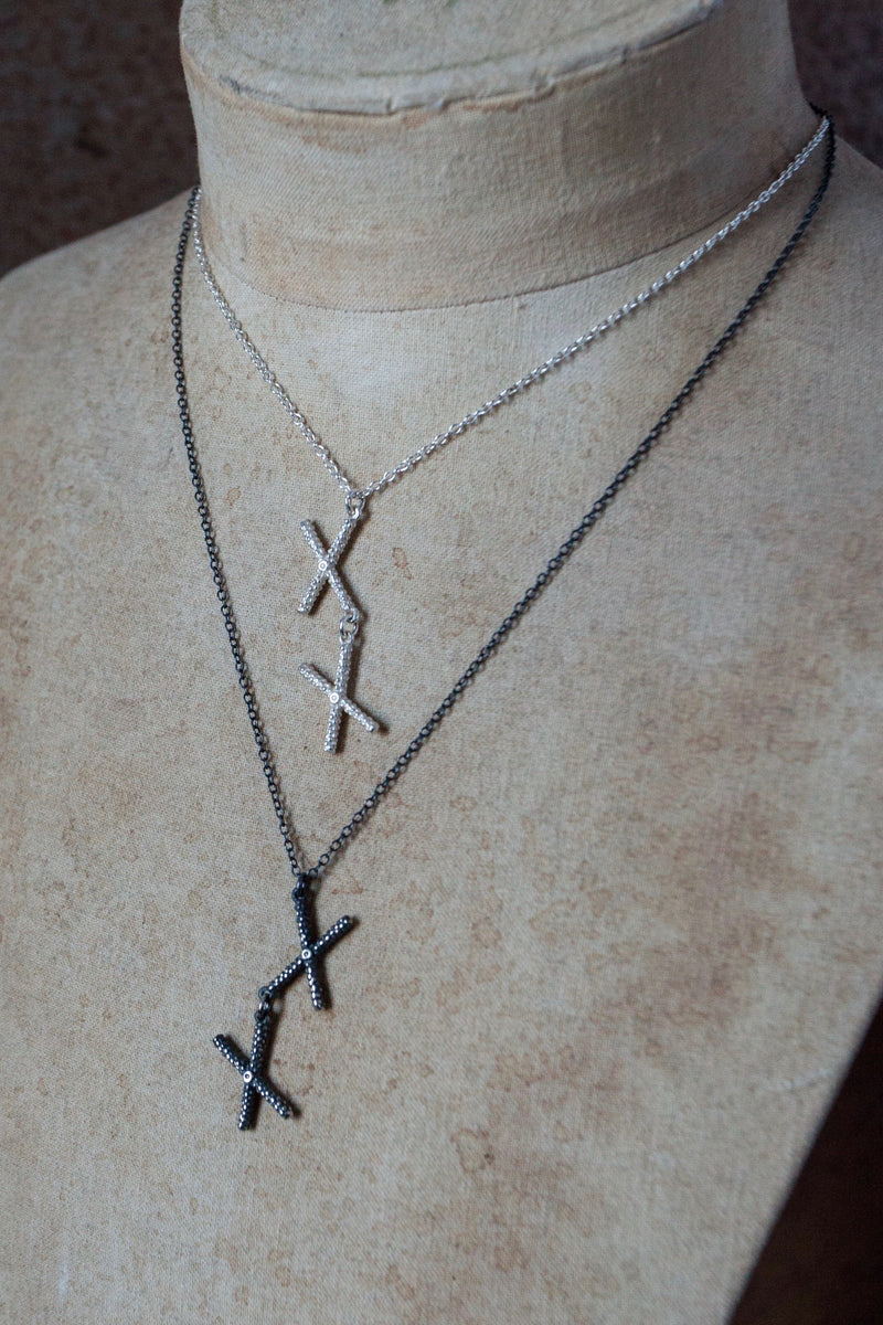 My Kiss Cross Pendant in silver and oxidised silver formed from a pair of linked crosses or kisses can be worn at two lengths