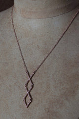 My Kiss Cross Necklace in rose gold is a geometric design formed from linked crosses or kisses
