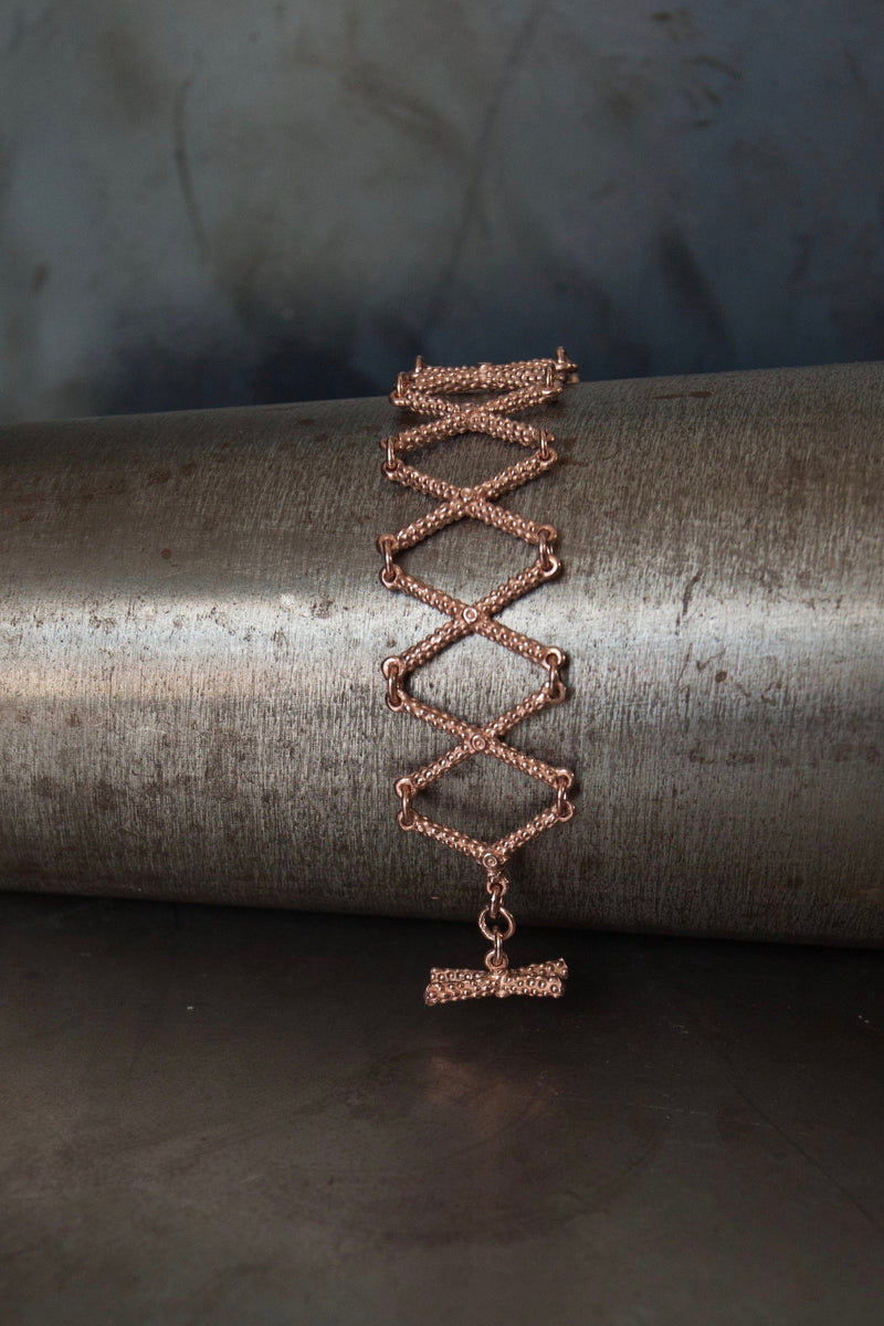 My Kiss Cross Bracelet in rose gold plated silver is a geometric design that links a row of crosses or kisses