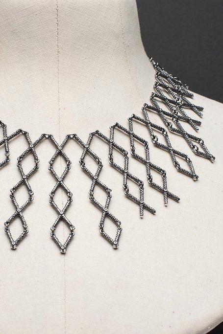 Close up of my Kiss Cross collar style necklace in oxidised silver made from interlocking cross shaped links