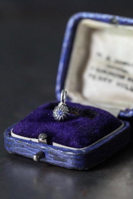 A delicate swirling gemstone charm – choose a Tanzanite for your December birthday. 